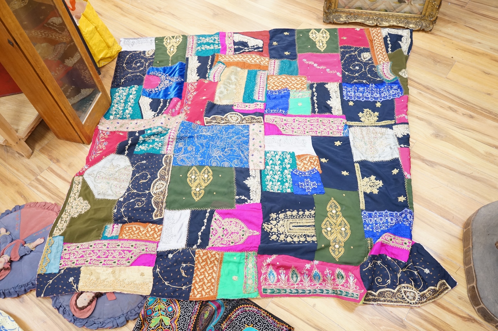 A quantity of mostly 20th century Middle Eastern and Indian woven and printed textiles and a peacock feather fan (2 boxes).